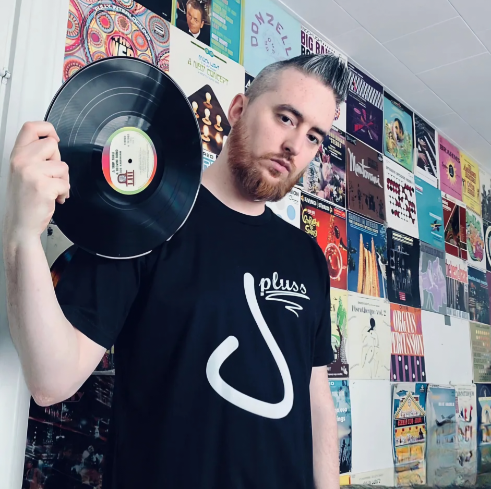 Jay Pluss Holding a Vinyl Record